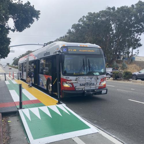 A bus pulls up to a temporary boarding platform on El Camino Real in South San Francisco.