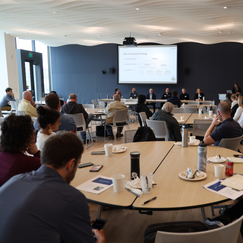 People sitting at tables in a meeting