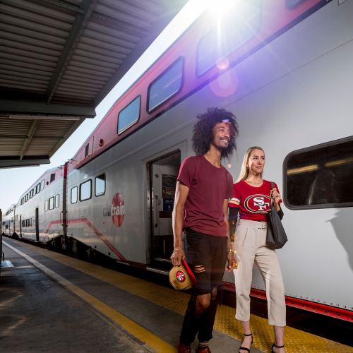 A couple of passengers getting off the train