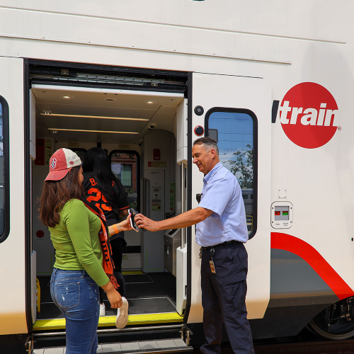 Train conductor scanning passengers mobile phone